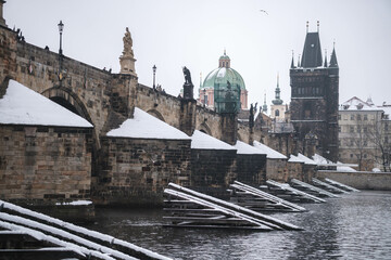 Romantic Snowy Prague gothic Castle with the Charles Bridge, Czech Republic