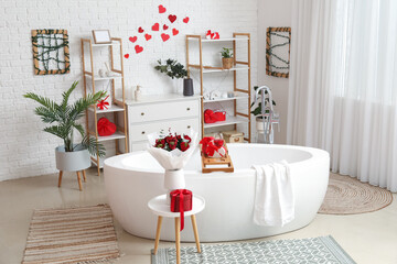 Interior of bathroom decorated for Valentine's Day with flowers, gifts and hearts