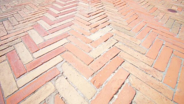 Orange shaped slabs laid out as city pavement and old brick floor pattern or exterior square construction extreme closeup Venice Italy