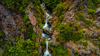 Drone Aerial of Picturesque Stream Flowing Between Mountain Atop Devil's Punchbowl Falls in New...
