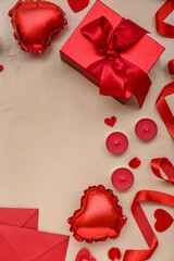 Composition with candles, gift box and balloons on color background. Valentine's Day celebration