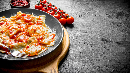 Ravioli with cherry tomatoes and sauce.