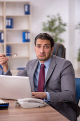 Young male employee working in the office