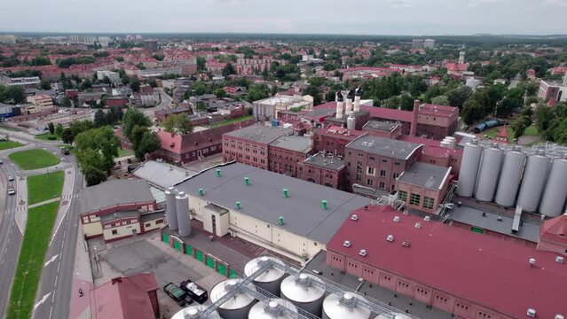 Brewery factory in Tychy, Poland from an aerial view on a beautiful sunny day. A giant beer brewing industry located in the Silesian Voivodeship.