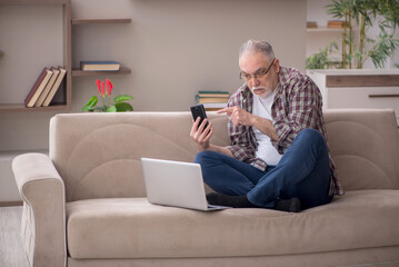 Old man working from home during pandemic