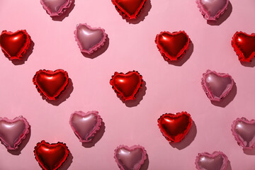 Composition with heart shaped balloons on pink background. Valentine's Day celebration