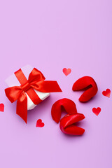 Composition with gift box and tasty fortune cookies on lilac background. Valentine's Day celebration