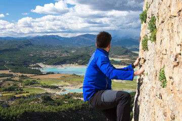 Intrepid mountaineer looking at the mountains from the top