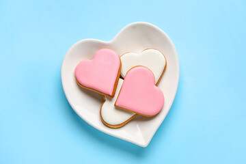 Plate with tasty heart shaped cookies on color background. Valentines Day celebration