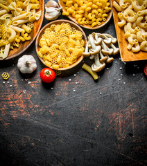 Different types of raw paste on a plate with garlic and mushrooms.