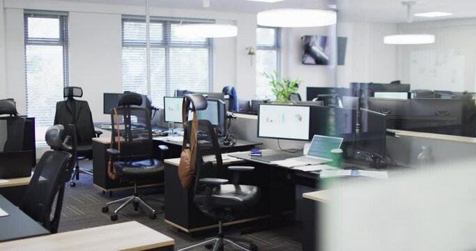 General view of empty modern office with multiple computers, slow motion