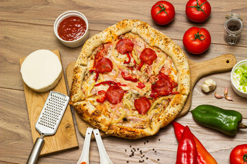 Sausage and vegetable pizza served on round wooden board
