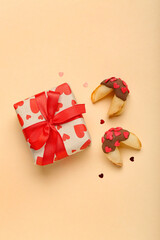 Fortune cookies with gift on beige background. Valentine's Day celebration