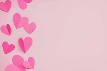 Composition with paper hearts on pink background. Valentines Day celebration