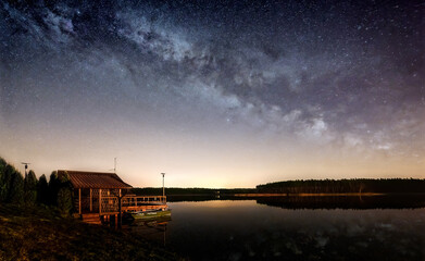 Milky way over a fisherman's hut at the lake