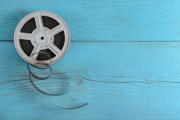 Old film strip on wooden background.