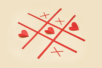 Tic tac toe game with paper hearts on color background. Valentines Day celebration © Pixel-Shot