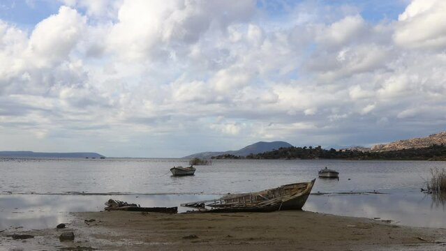 Fishing boats moored along the shore of Lake Bafa in Turkey.	
