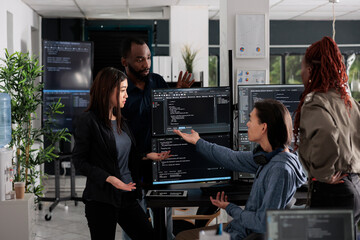 Multi ethnic web developers writing script while talking about develop cloud computing server. IT...