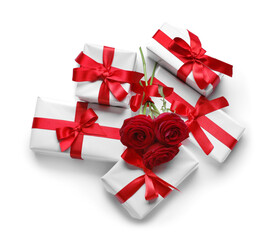 Gift boxes with beautiful bows and rose flowers isolated on white background. Valentine's Day celebration