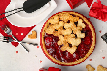 Plate with sweet strawberry pie, cookie hearts and gifts for Valentine's day on white background