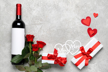 Fototapeta premium Frame made of bottle of wine, rose flowers, gifts and paper hearts. Valentine's Day celebration