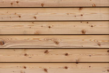 Fototapeta premium A texture of brown boards with knots and resin painted with impregnation for wood