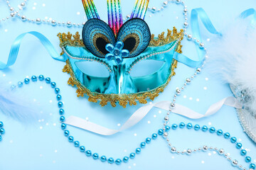 Carnival mask with beads and confetti on blue background