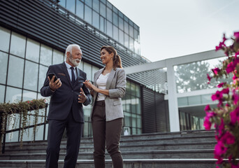 Business people talking in front of office building