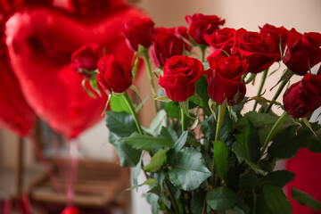 Fototapeta na wymiar Red roses for Valentine's Day in living room, closeup