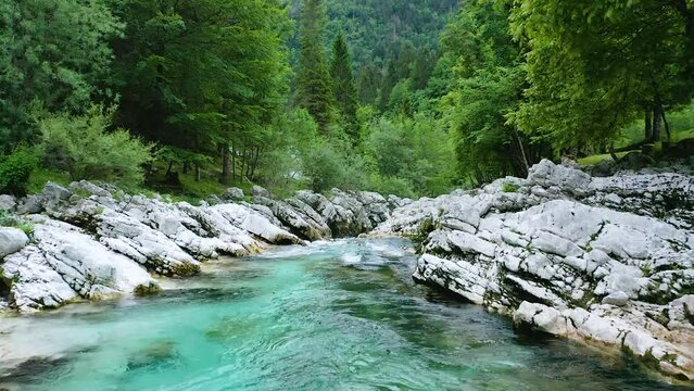 Flying With Flow of Beautiful Emerald Soča River at Small Gorge Soča River Surrounded With Majestic Tolmuns. Cliffs Reflect The Color Patterns Of The Soča River, As it Winds Through Narrow Canyons.