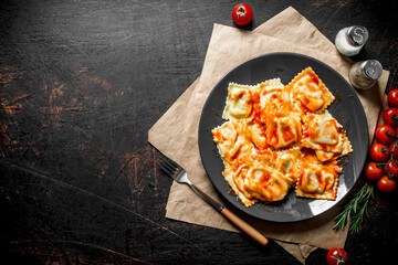 Ravioli with spices , rosemary, sauce and tomatoes.