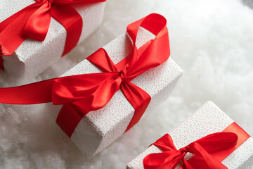 Beautiful gift. New Year's decor. Preparation for the holiday. White snowy background. Close up.