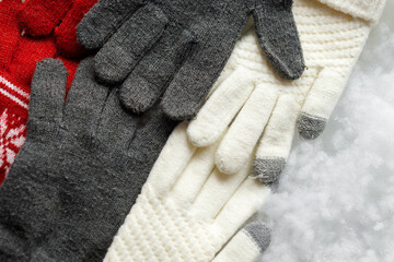 Gloves on a white background. Snowy background. Close up. COPY SPACE.