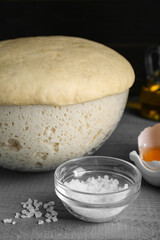 Fototapeta na wymiar Fresh yeast dough and ingredients on grey wooden table, closeup