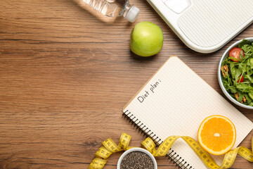 Weight loss concept. Flat lay composition with notebook, measuring tape and different products on...