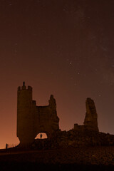 Obraz premium Caudilla castle in ruins at night with the Milky Way. Spain