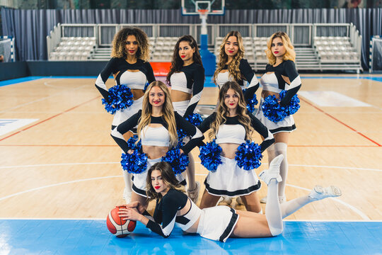 Full shot of a cheerleading squad posing for a picture in three rows. Sport concept. High quality photo