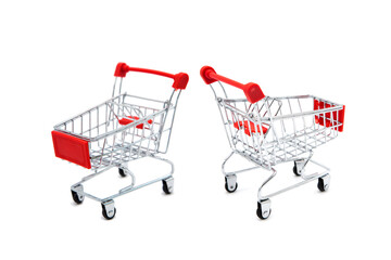 Empty supermarket shopping cart in two perspectives isolated on white background. Copy space.