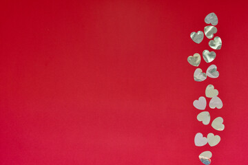Hearts of paper on red textured background. San Valentine day concept.