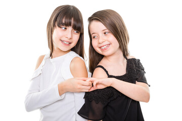 two child girls are sisters and best friends show togetherness and happiness by holding hands and look to each other