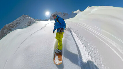 PORTRAIT, SELFIE: Male snowboarder riding snowboard on fresh untracked snow