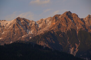 warm sunset in the mountains with a view on the ridge