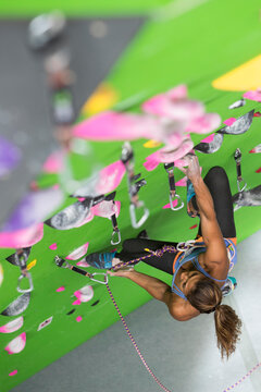 Female climber training on climbing wall, Louisville, Colorado, USA