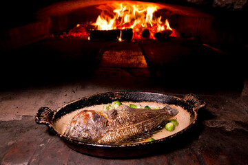 Seafood in a brick oven fire.