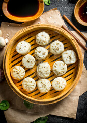 Traditional food. Dumplings manta with soy sauce in bowls.
