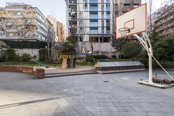 Children's play area and basketball hoop in the inner courtyard of an urban residential housing...