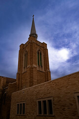 Fototapeta premium Church building on the city street and dramatic cloudscape, the First Baptist Church in Odessa, Texas, USA