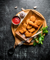 Chicken nuggets with parsley, sauce and garlic.