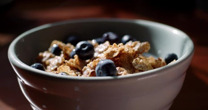 Tracking Close-up of a healthy bowl of cereal with blueberries. 4K ProRes 422 HQ DCI 4096 x 2160. Shot on the Blackmagic Cinema Camera 6K Pro on a slider, with rack focus and natural morning light.